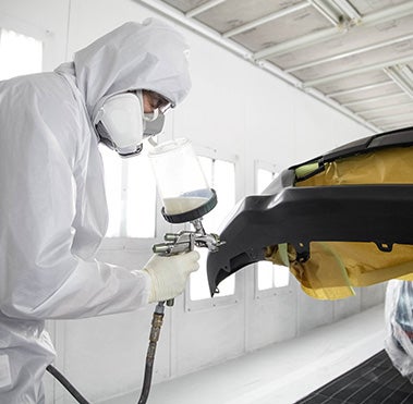 Collision Center Technician Painting a Vehicle | Orem Toyota in Orem UT