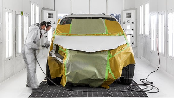 Collision Center Technician Painting a Vehicle | Orem Toyota in Orem UT
