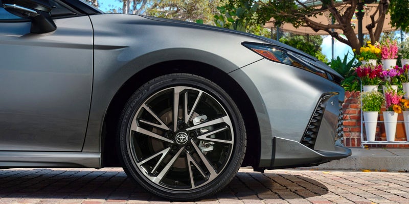 2025 Toyota Camry next to flowers