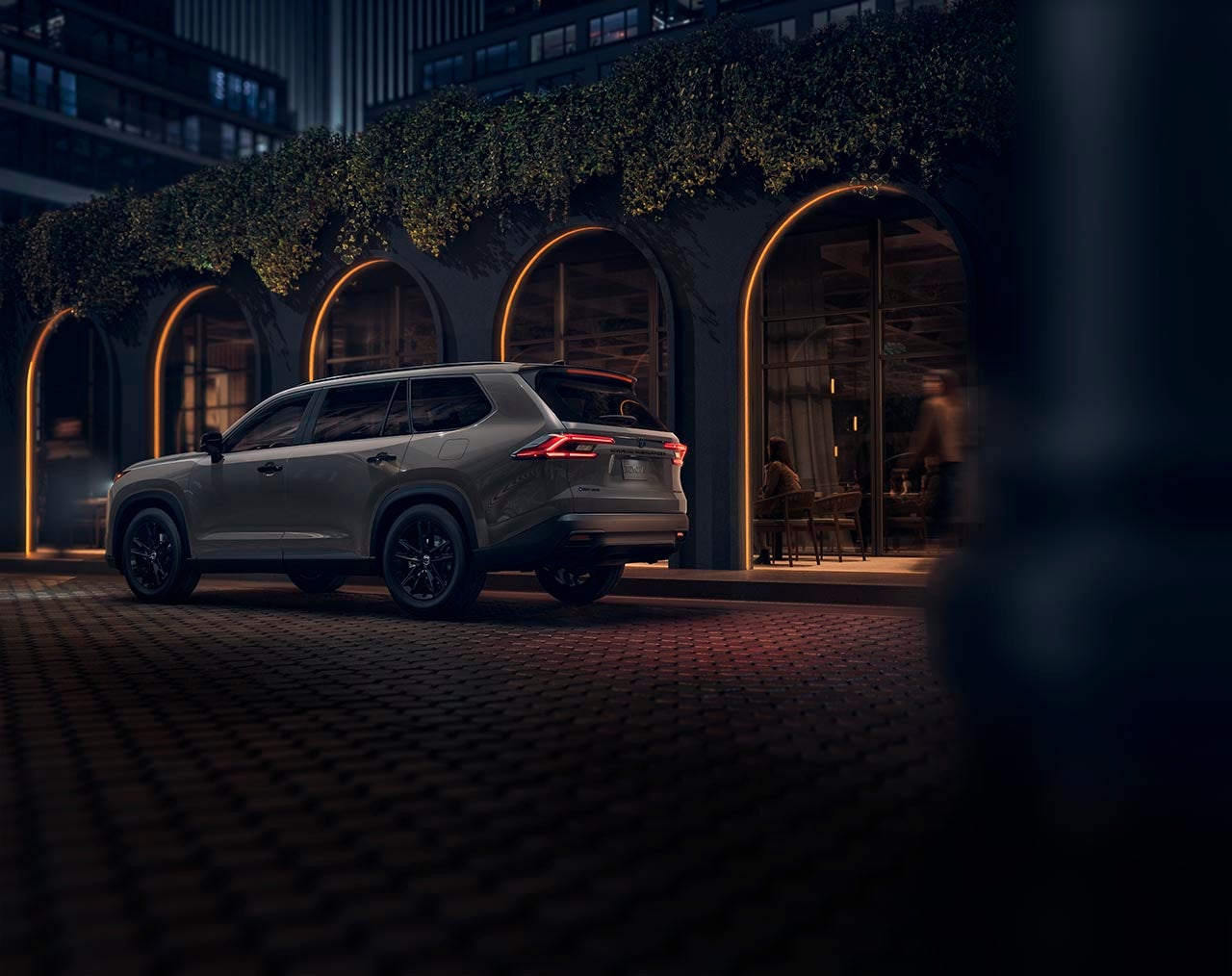 Toyota Grand Highlander Hybrid on street at night
